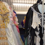 The Costume Workshop with costumes hanging on the shelves - showing the first costume on the rail