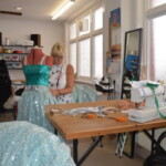 An image of costumier at The Costume Workshop adjusting a costume.