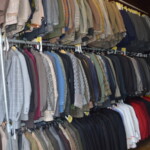 Image showing male character costumes in Workshop hanging on rails