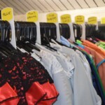 The Costume Workshop with costumes hanging on the shelves - showing the character names on the hangers